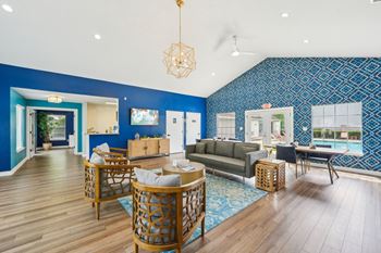A living room with a blue wallpaper and wooden furniture.